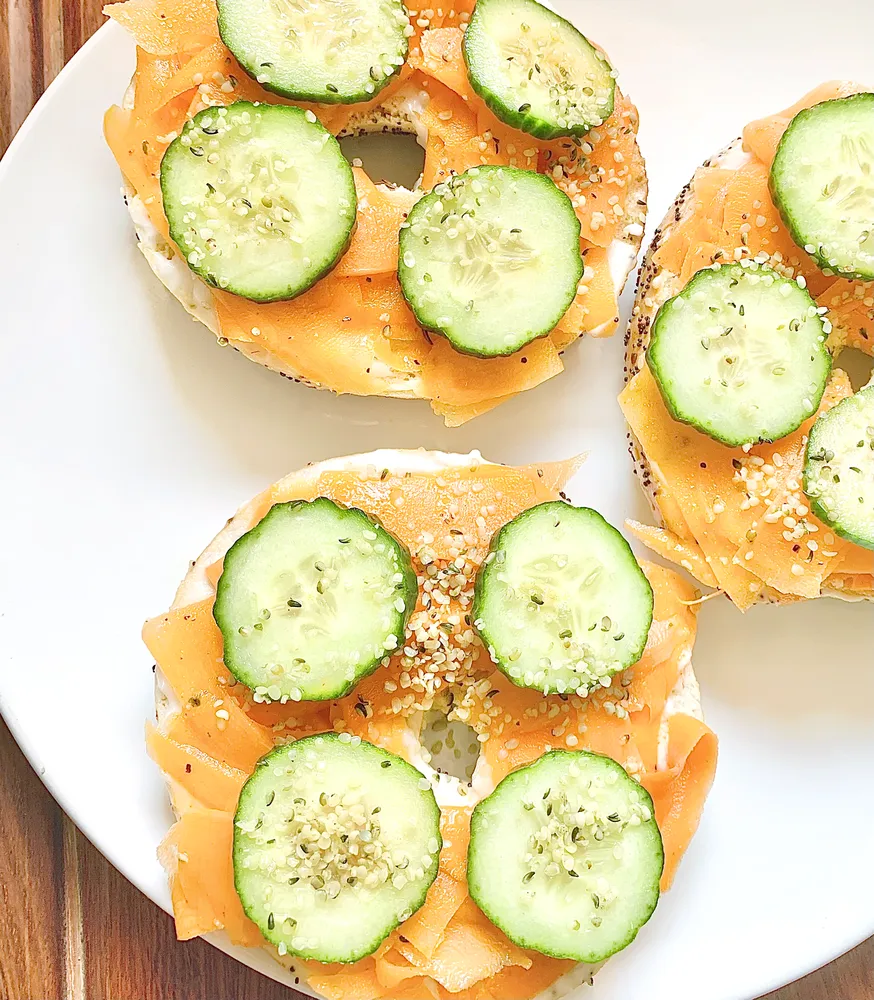 carrot lox bagels with cucumber and hemp seeds