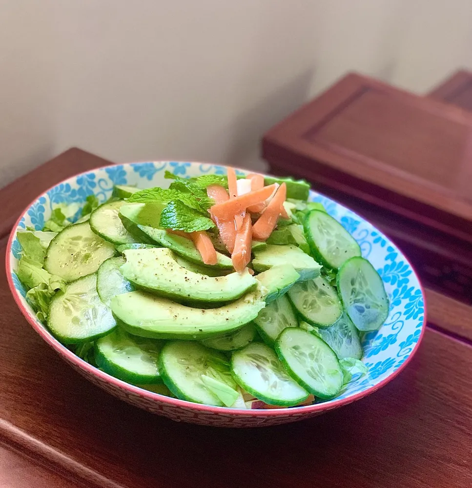 cucumber salad in a patterned bowl