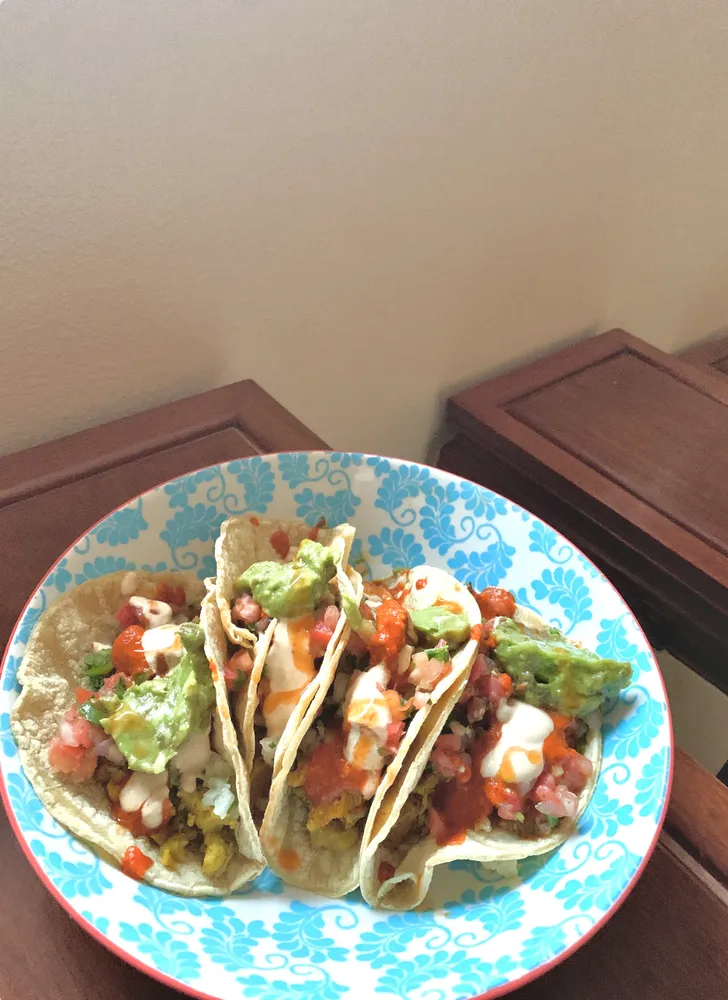 three veggie tacos on a patterned plate