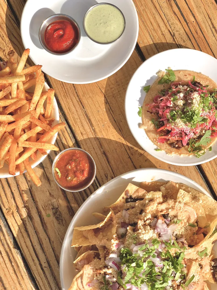 a shared spread — bowls, fries and salsa